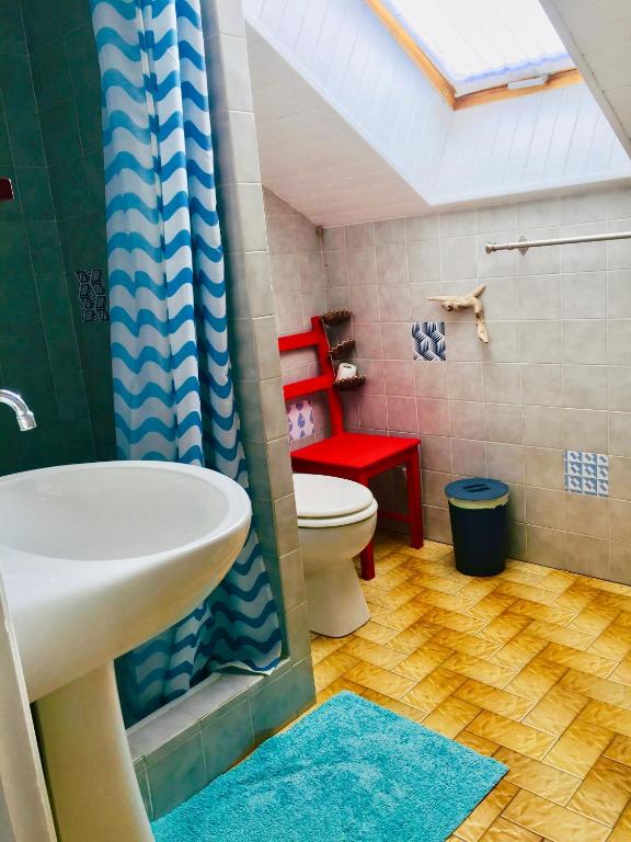 a bathroom with a toilet and a sink and a shower at Location Le Queron in Guillestre