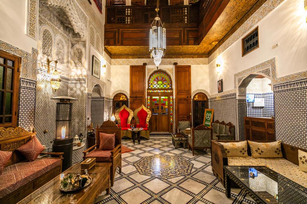 a living room filled with furniture and a ceiling at Dar Borj in Fès