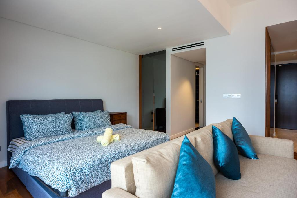 a bedroom with a bed with a teddy bear on it at Anggun Residences Luxe in Kuala Lumpur