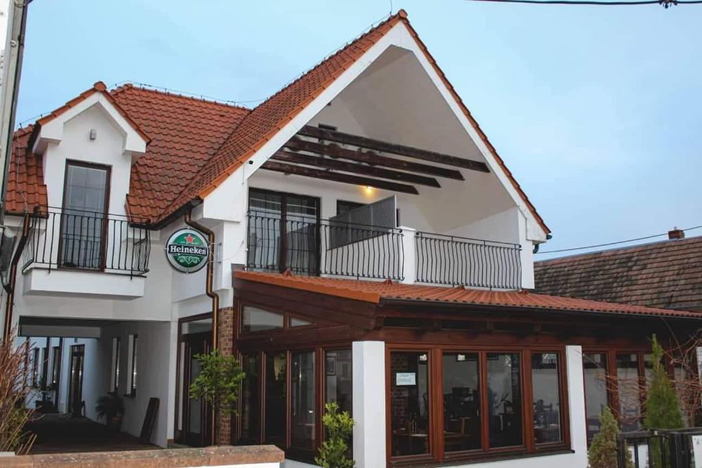 a white house with a red roof at Il Galeone hotel in Stupava