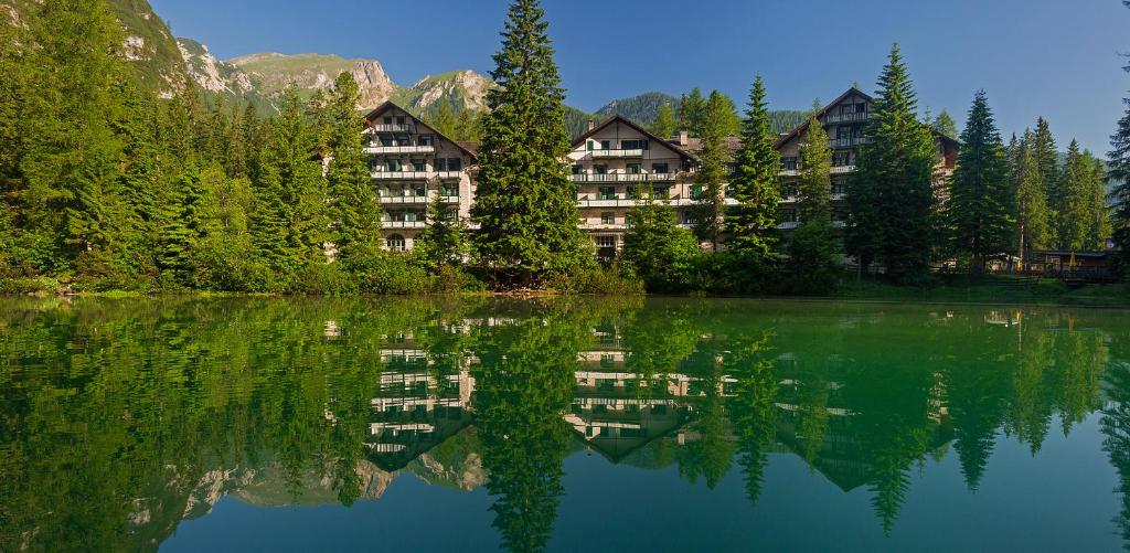 a reflection of a building in a lake at Hotel Lago di Braies in Braies