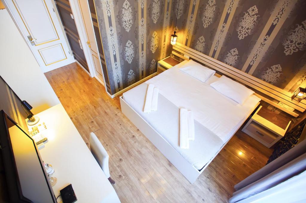 Postel nebo postele na pokoji v ubytování Rustaveli Hotel