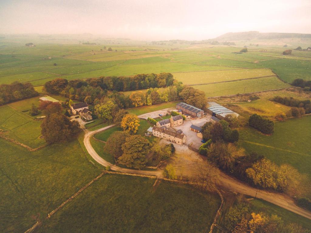 an aerial view of a house in the middle of a field at Shippon Cottage - Brosterfield Farm in Eyam