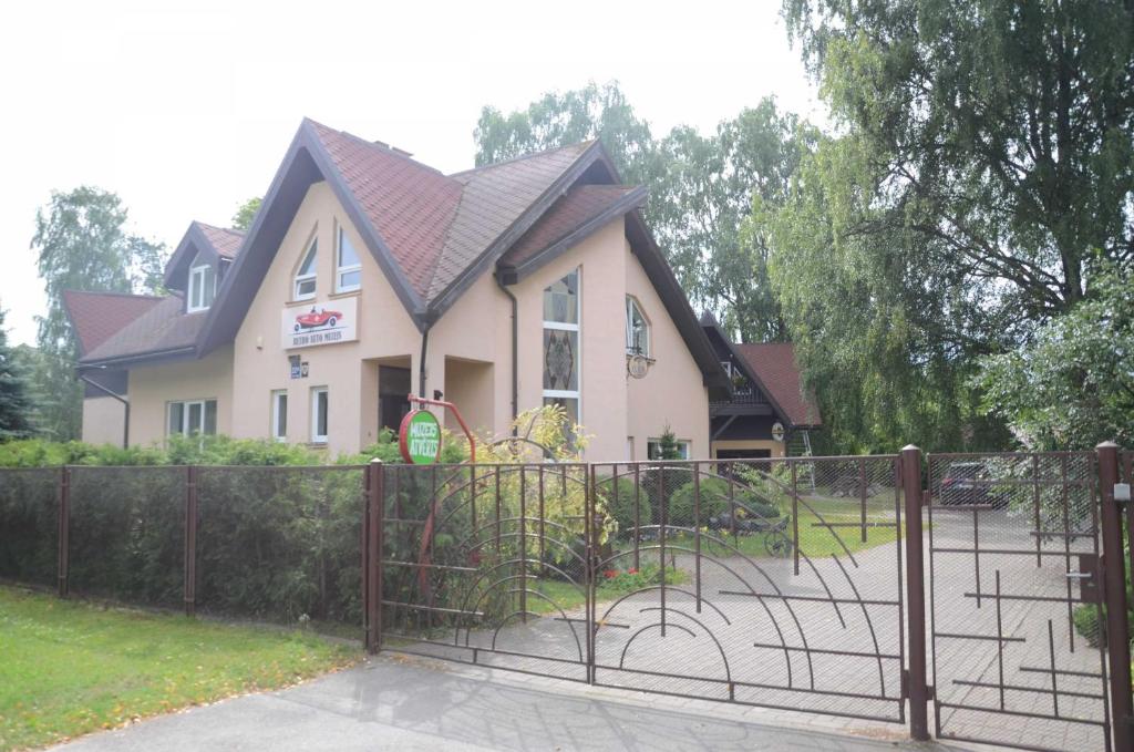 a house with a gate in front of it at Classic Car Museum Apartment in Riga