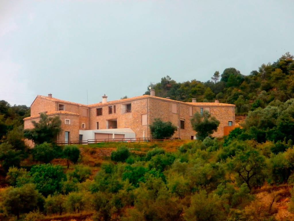 a large brick building on top of a hill at Hotel Casa Fumanal in Abizanda