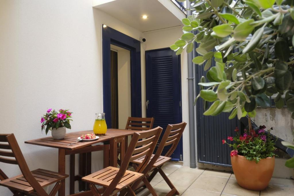 a table and chairs on a patio with plants at Oporto Wall Apartments in Porto