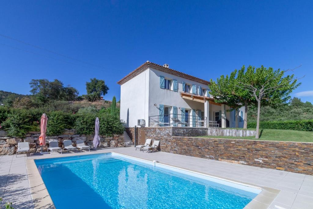 a swimming pool in front of a house at La Gaoute in Sainte-Maxime