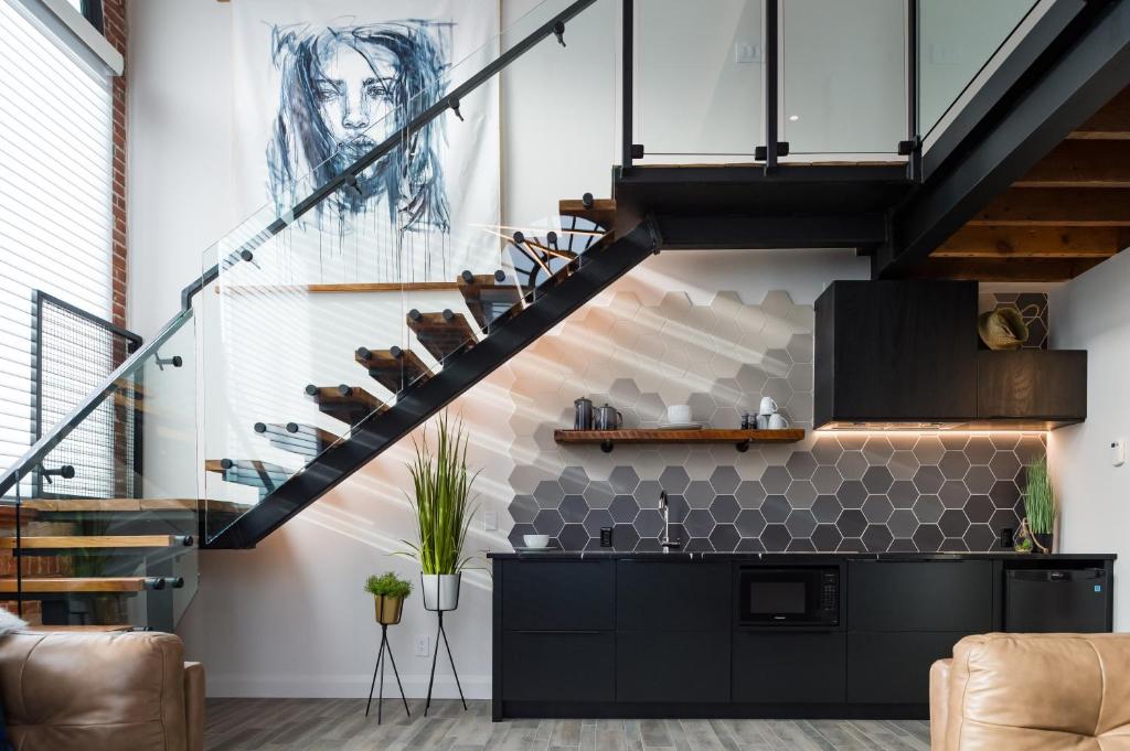 a staircase in a living room with a drawing on the wall at 48 King West in Brockville