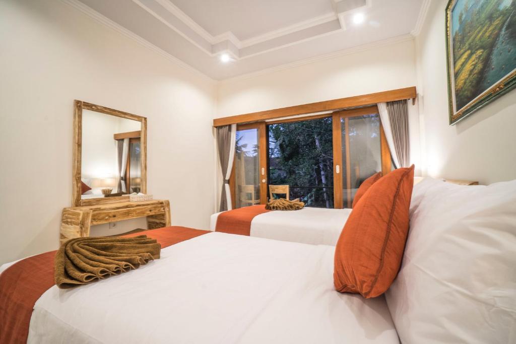 Postel nebo postele na pokoji v ubytování Adenia House Ubud