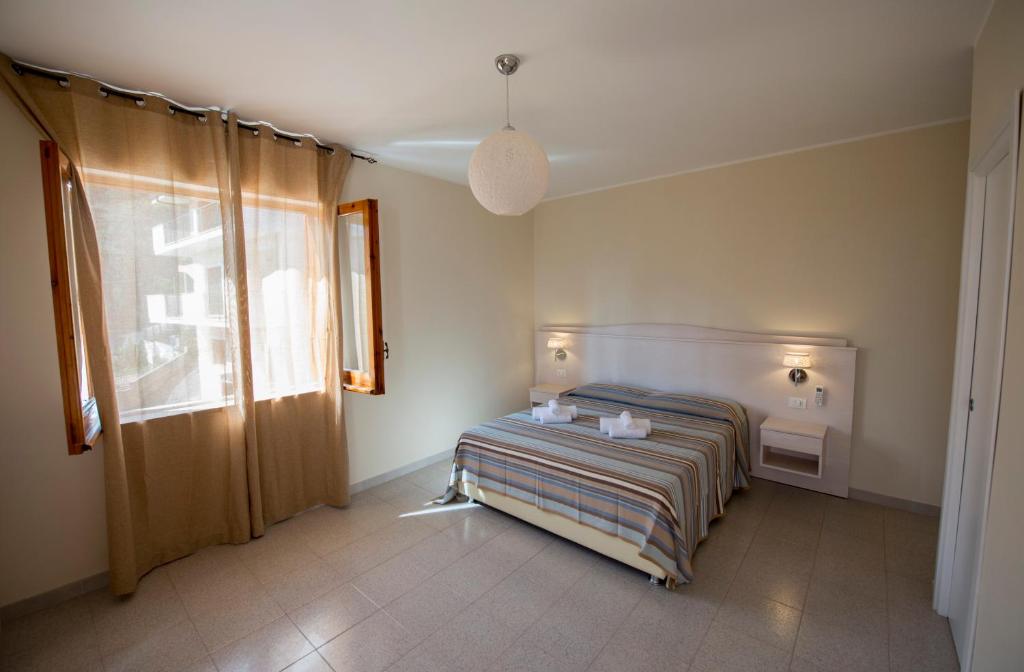 Postel nebo postele na pokoji v ubytování Donna Rosa Accommodation