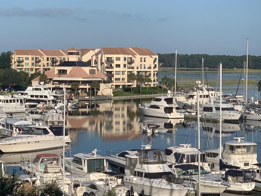 a bunch of boats docked in a marina with buildings at Newly Remodeled Hilton Head Villa in Hilton Head Island
