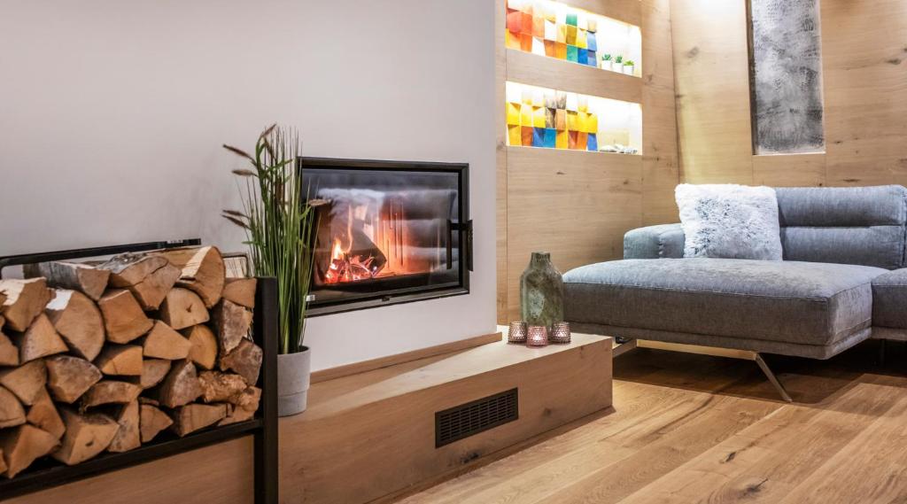 a living room with a fireplace and a couch at Forest Soul Deluxe Apartments in Bjelašnica