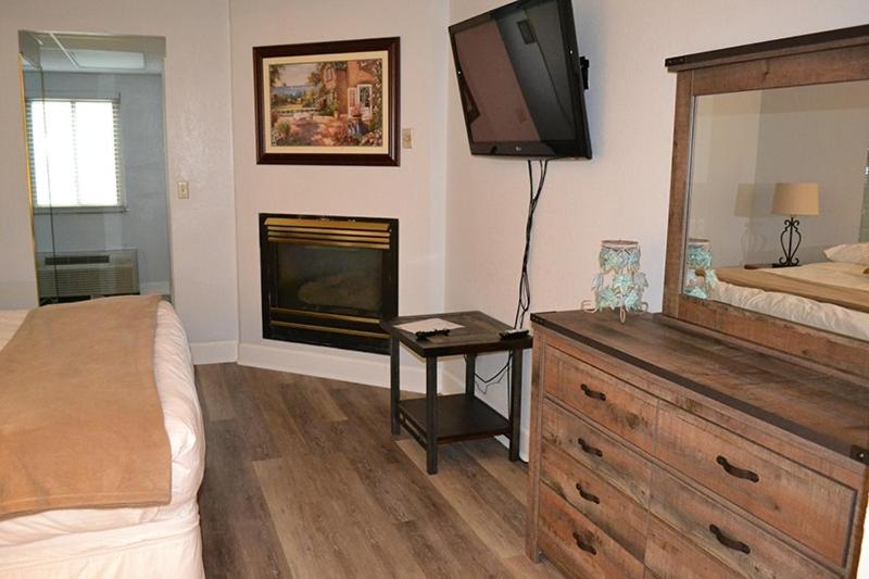 a bedroom with a bed and a dresser with a television at River Place Condos #409 1BD, 2Bath in Pigeon Forge