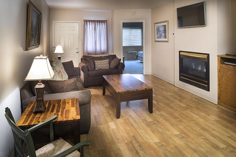 a living room with a couch and a table at River Place Condos #602 2BD in Pigeon Forge