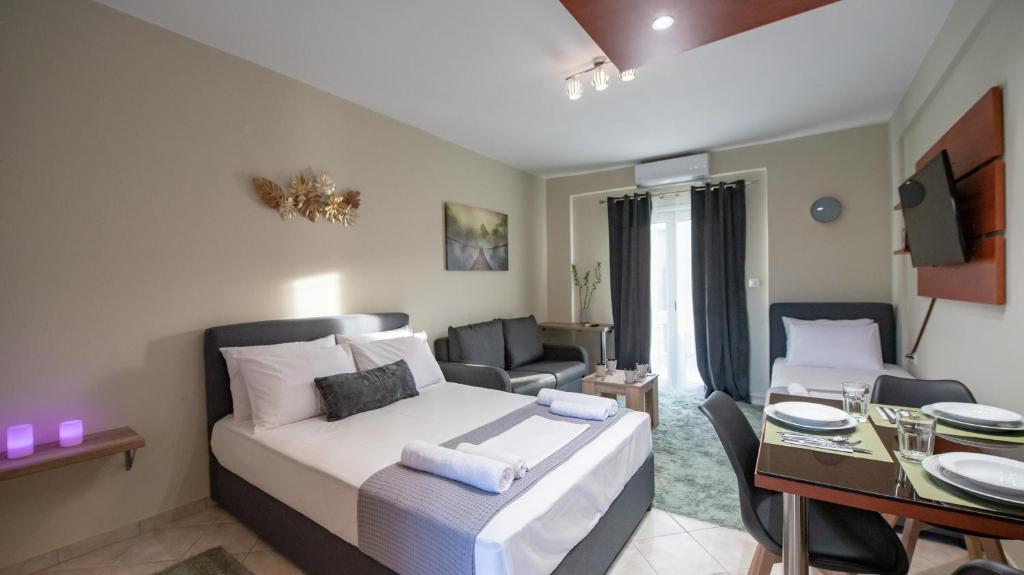 a bedroom with a bed and a living room at Alfa House in Ioannina