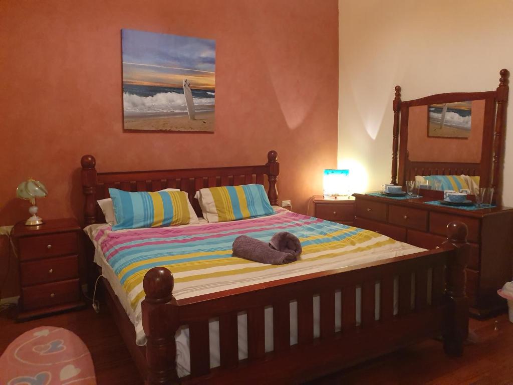 a bedroom with a bed with a stuffed animal on it at JUST-4-YOU! amazing sea views, WIFI, fully air-conditioned, king bed in Vincentia