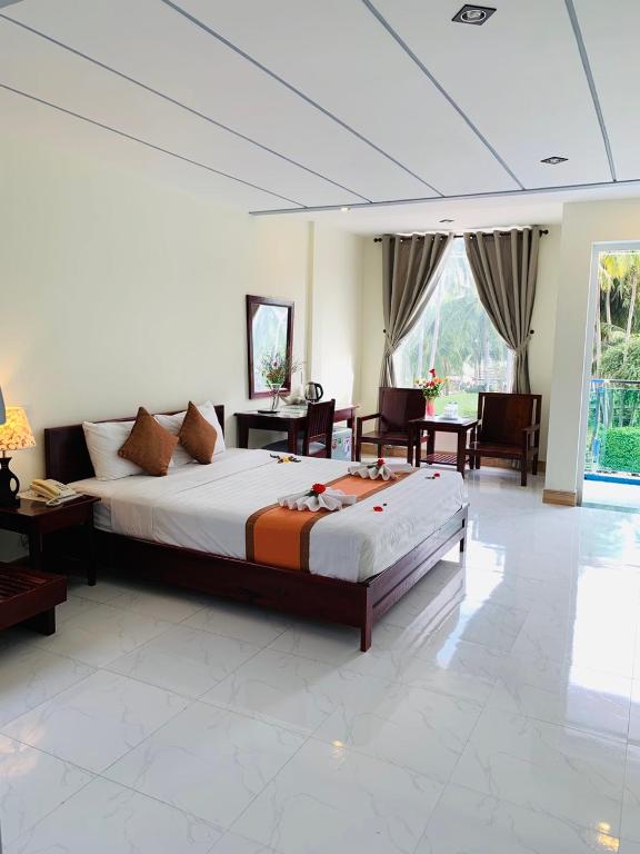 Giường trong phòng chung tại Ha Anh Hotel - Mui Ne