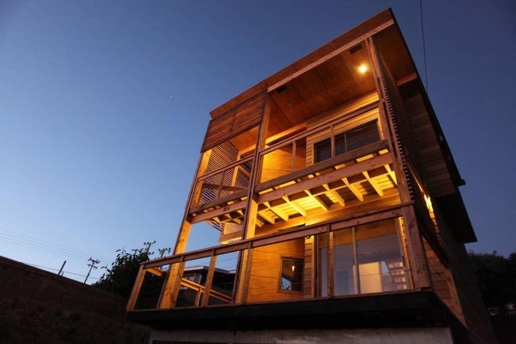 a tall building with many windows on the side of it at Tongoy Beach Tinyhouse in Tongoy