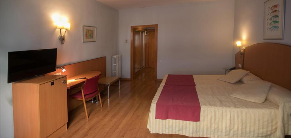 Postel nebo postele na pokoji v ubytování Hotel Reconquista