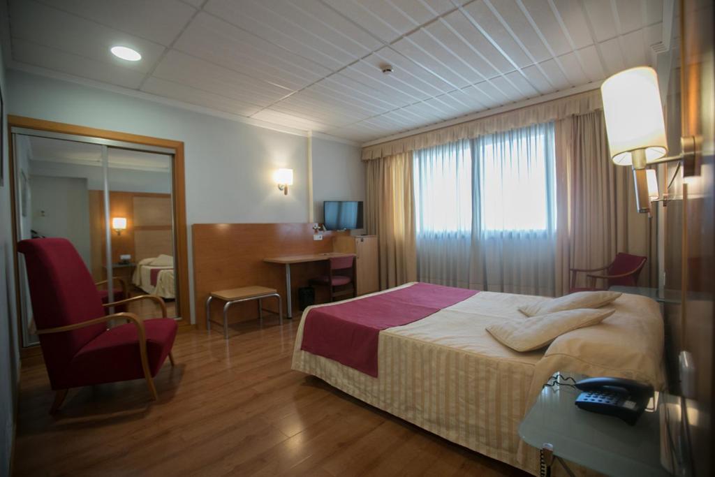 Postel nebo postele na pokoji v ubytování Hotel Reconquista