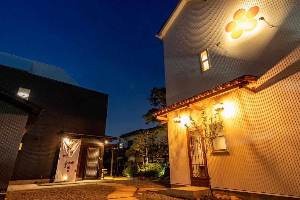 a house with lights on the side of it at night at Sendai Guest House UMEBACHI in Sendai