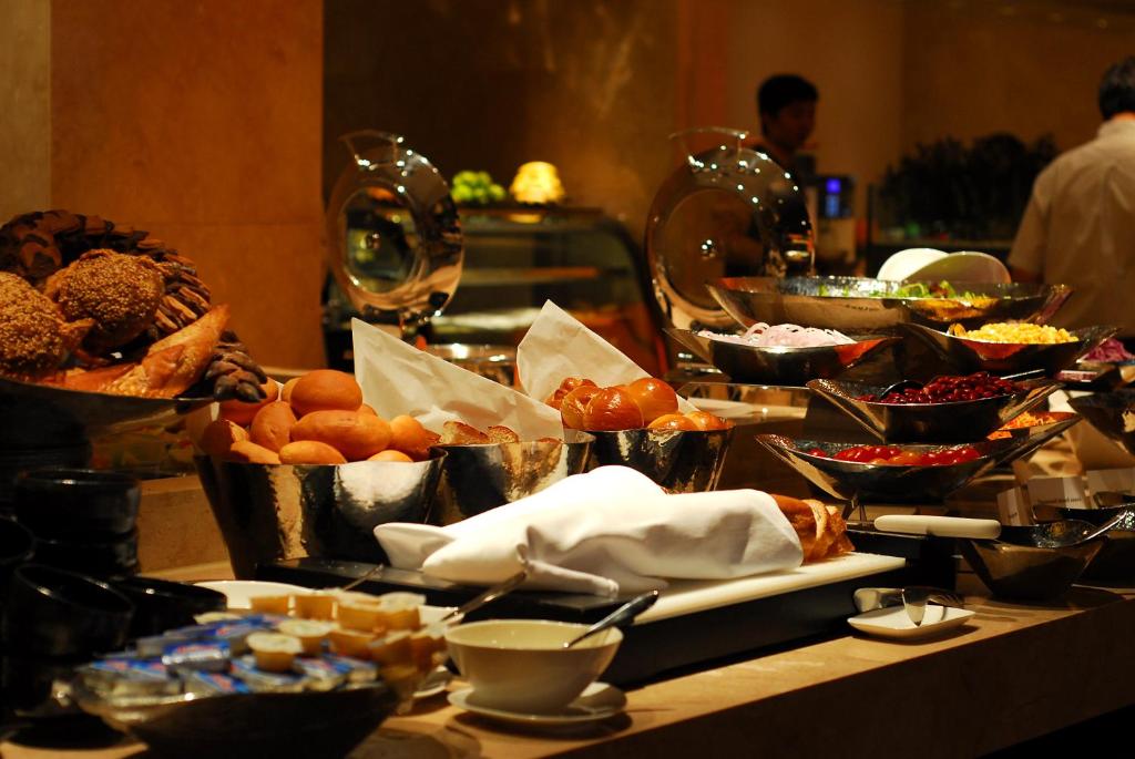 a buffet with many different types of food on a table at Belgravia Serviced Residence Wuxi in Wuxi