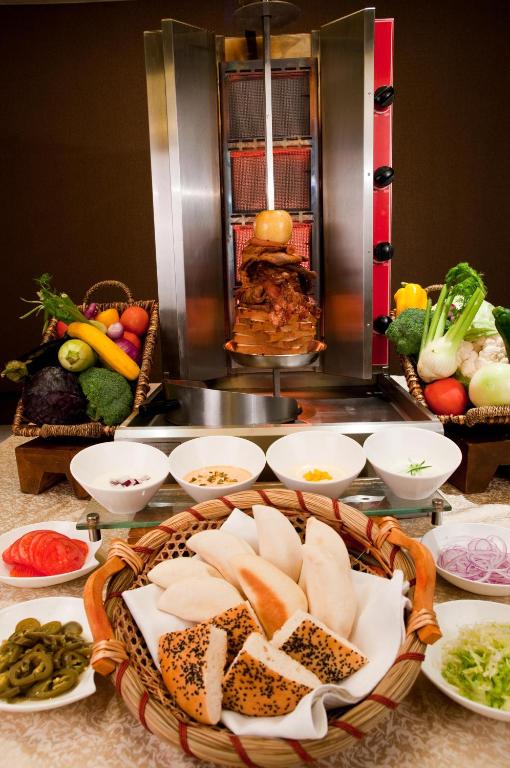 a table topped with plates and bowls of food at Belgravia Serviced Residence Wuxi in Wuxi