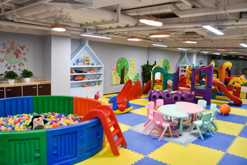 a play room with a table and play equipment at Belgravia Serviced Residence Wuxi in Wuxi
