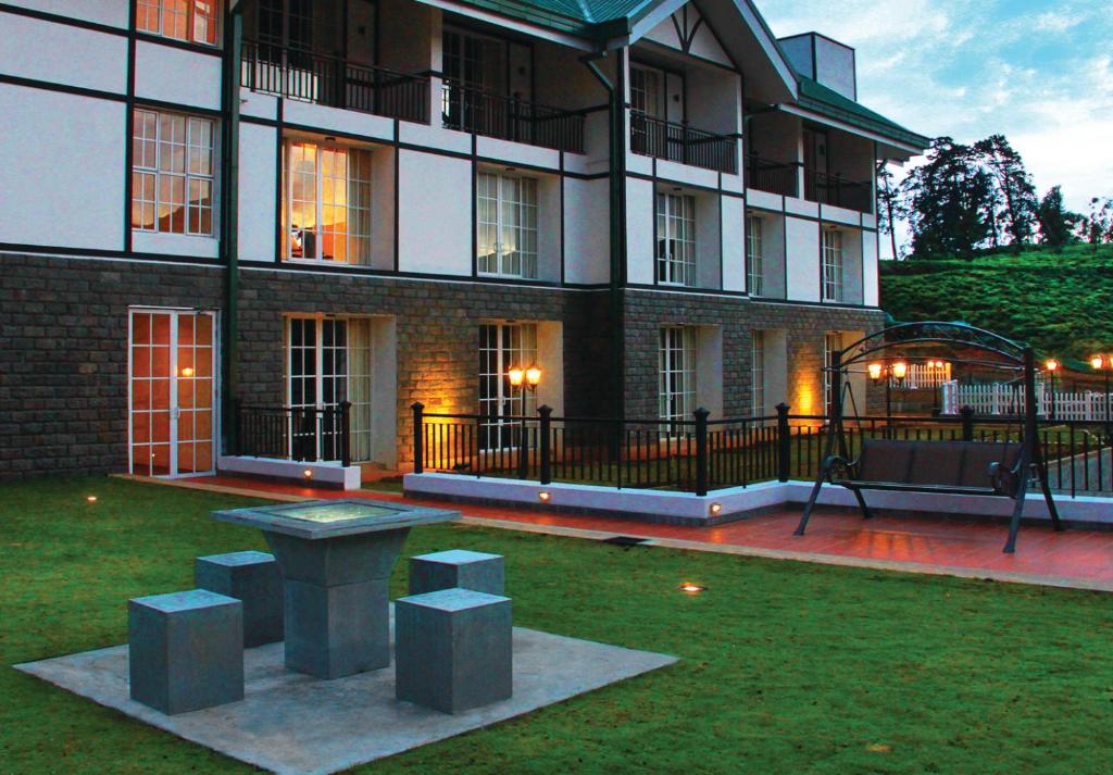 a building with a bench in front of it at The Blackpool Resort & Spa in Nuwara Eliya