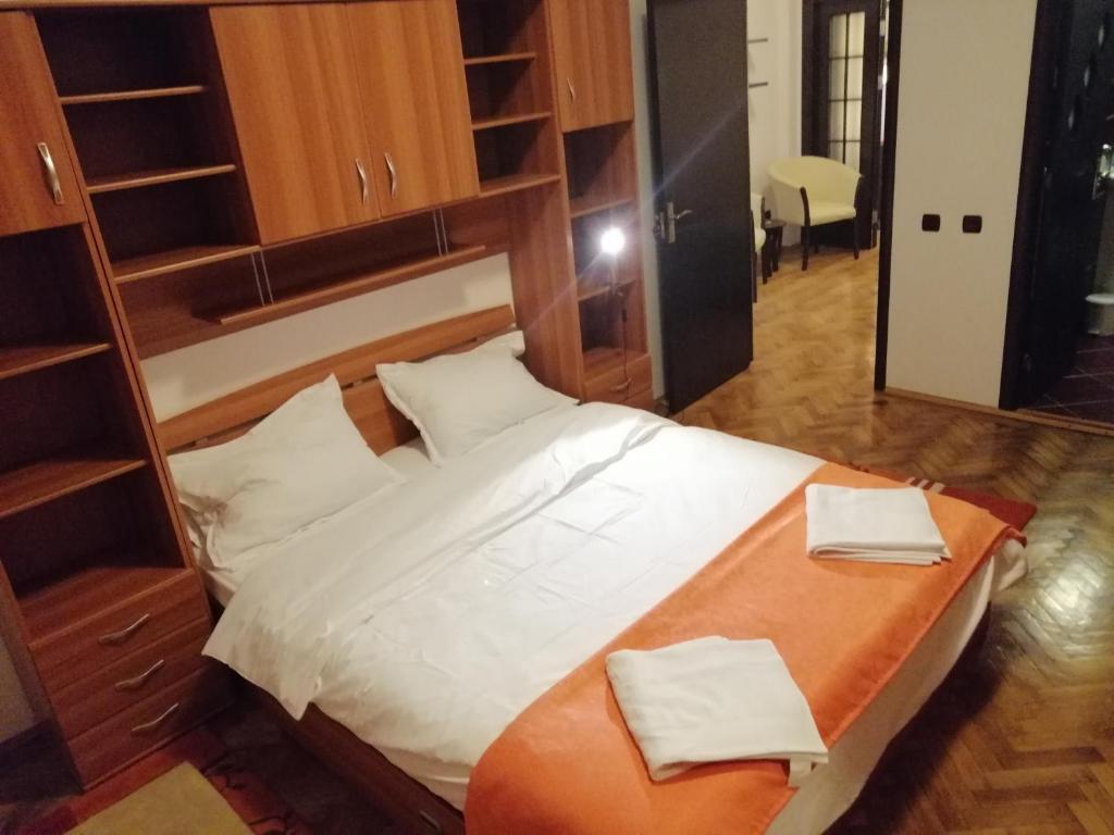 a bedroom with a bed with two towels on it at Apartament Athenee Palace Bucharest in Bucharest