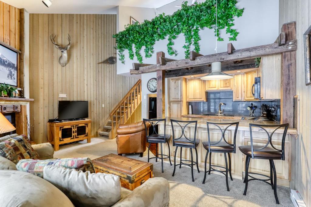 a living room and kitchen with a couch and chairs at Mt Bachelor Village Ski House # 262 in Bend