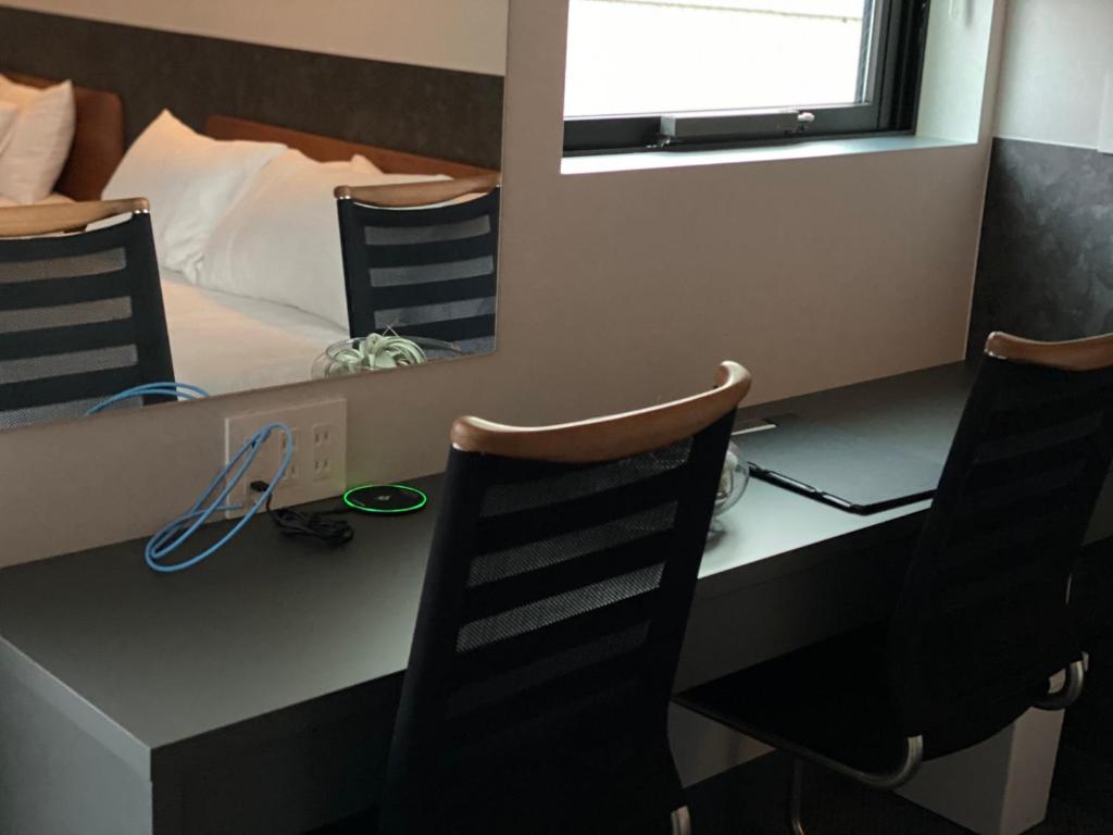 Postel nebo postele na pokoji v ubytování Hotel 草石庵