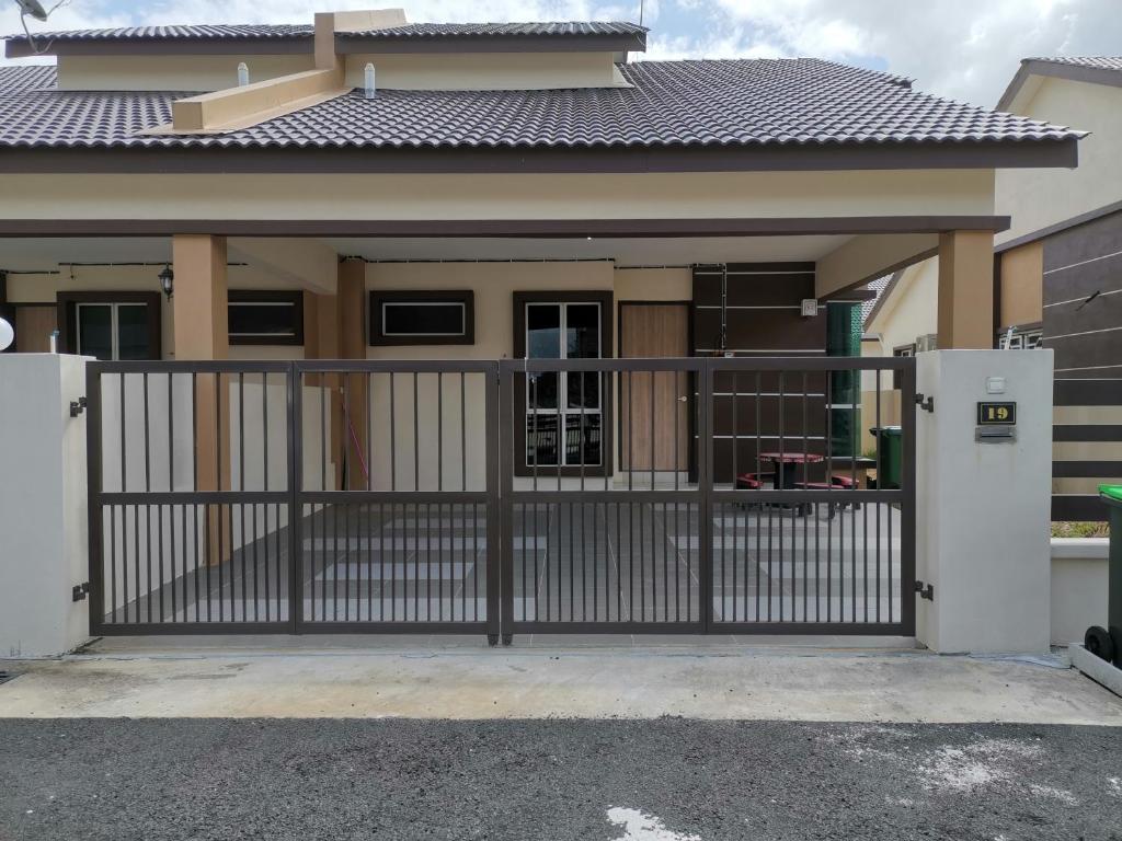 a house with a gate in front of it at Homestay An-nur in Alor Setar