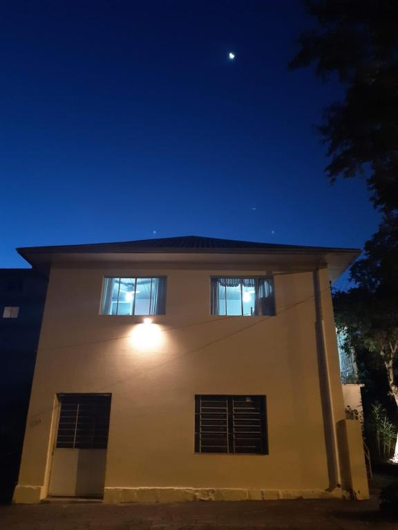 a house with two windows at night at Hostel Famiglia Susin in Caxias do Sul