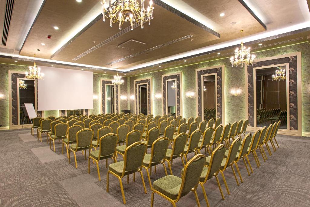 a conference room with a row of chairs and a screen at Limak Eurasia Luxury Hotel in Istanbul