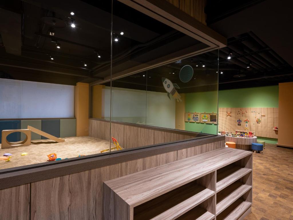 a childrens play area with a large glass wall at Kung Shang Design Hotel in Kaohsiung