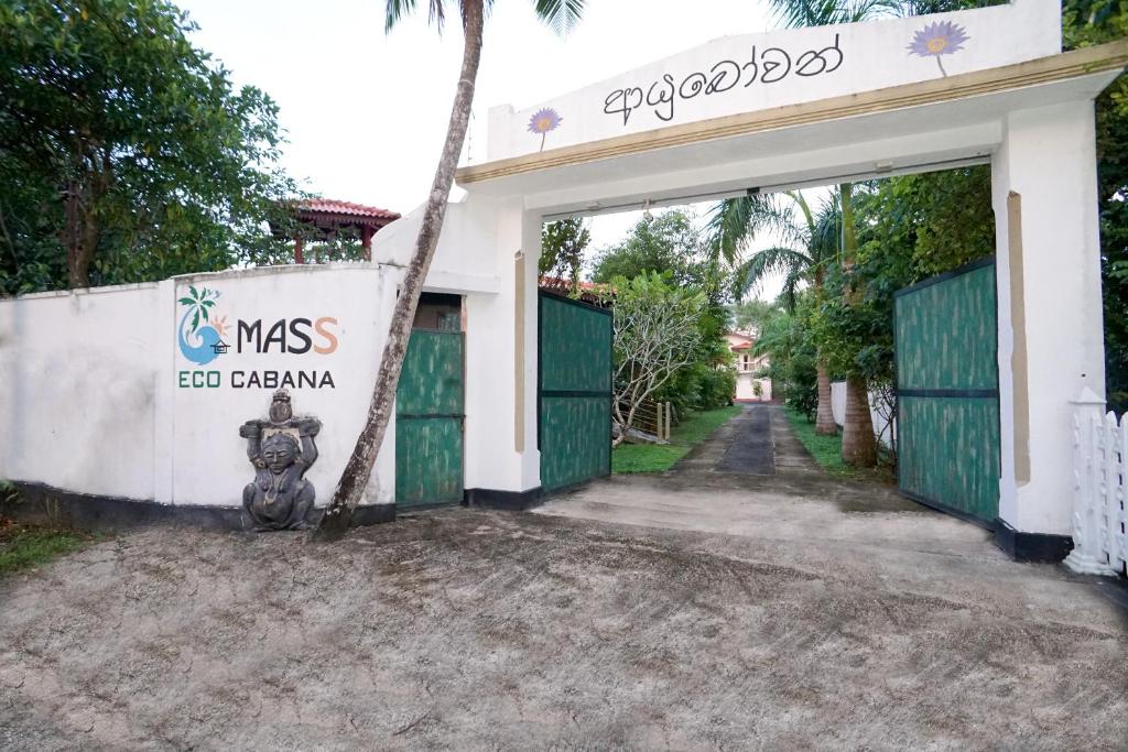 a motorcycle parked in front of a building with a garage at Mass Eco Cabana Yoga & Spa - Unawatuna in Unawatuna