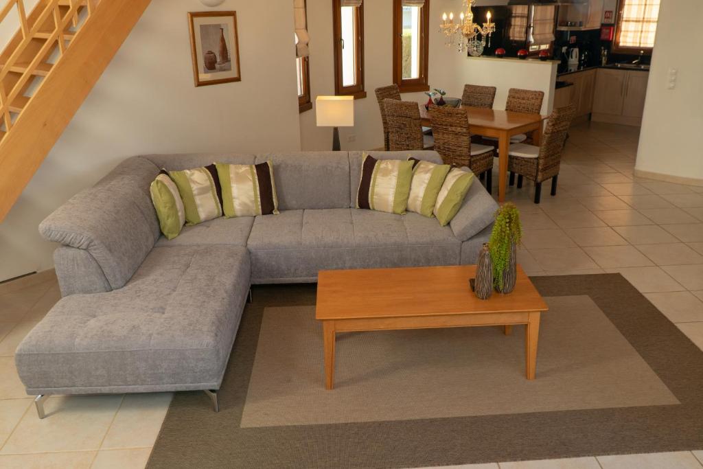 a living room with a couch and a table at AlmaVerde Village & Spa Resort in Burgau