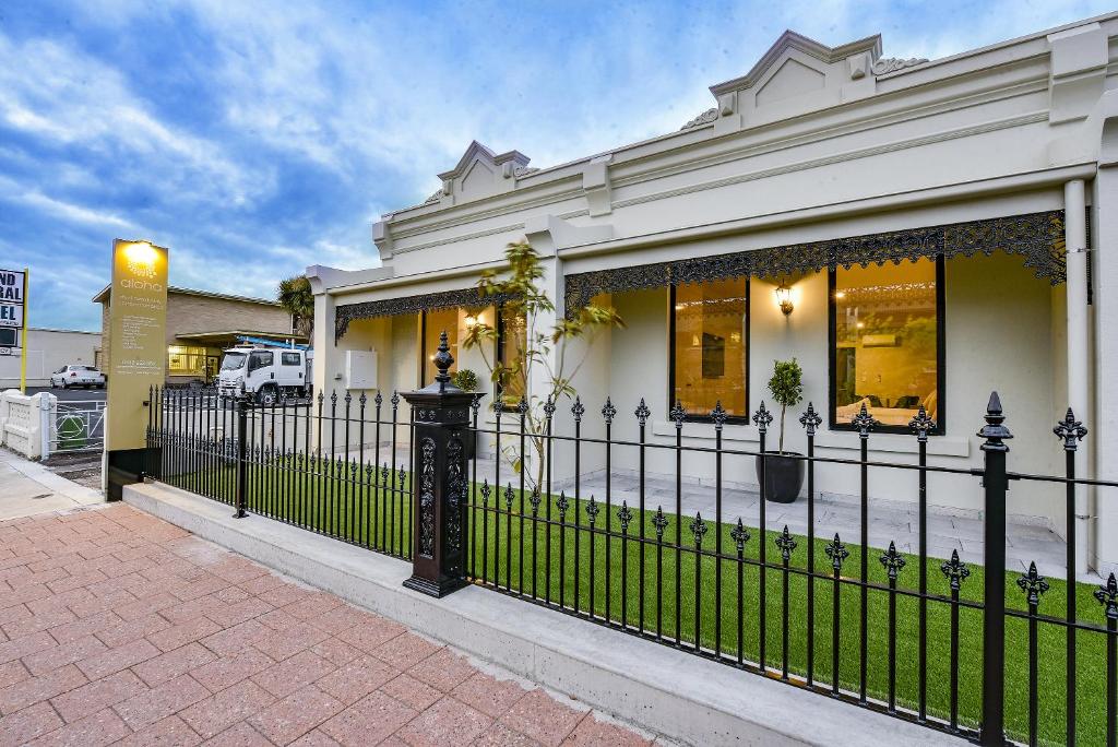 a black fence in front of a house at Aloha Central Premium Studios in Mount Gambier