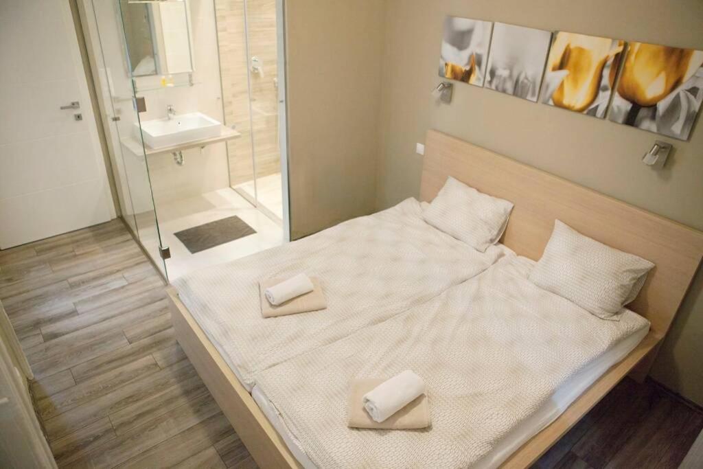 a bed with two towels on it in a bathroom at Apartment Downtown Regiposta 15 in Budapest