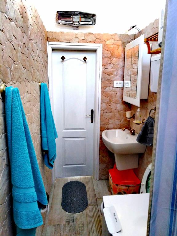 a bathroom with a white door and a sink at Apartment Mediterraneo Blue Sky in Perast