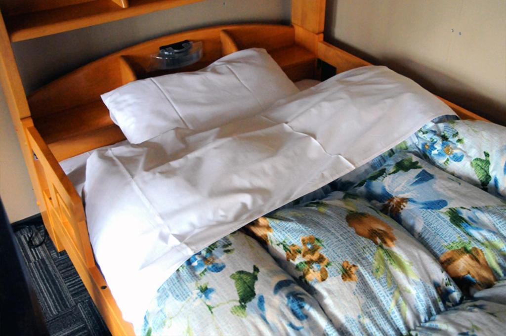 Postel nebo postele na pokoji v ubytování Sakura Guest House