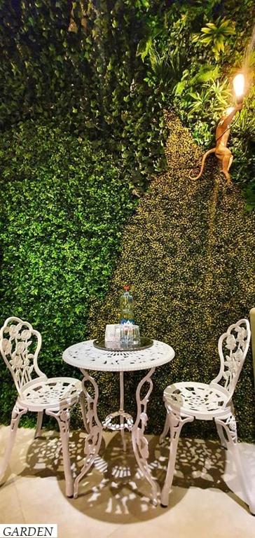 a table with two chairs and a table with a cake on it at Hotel Ramka & Restaurant & Wine Bar in Poznań