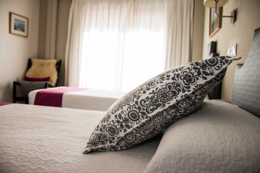 Postel nebo postele na pokoji v ubytování Hotel Jávea