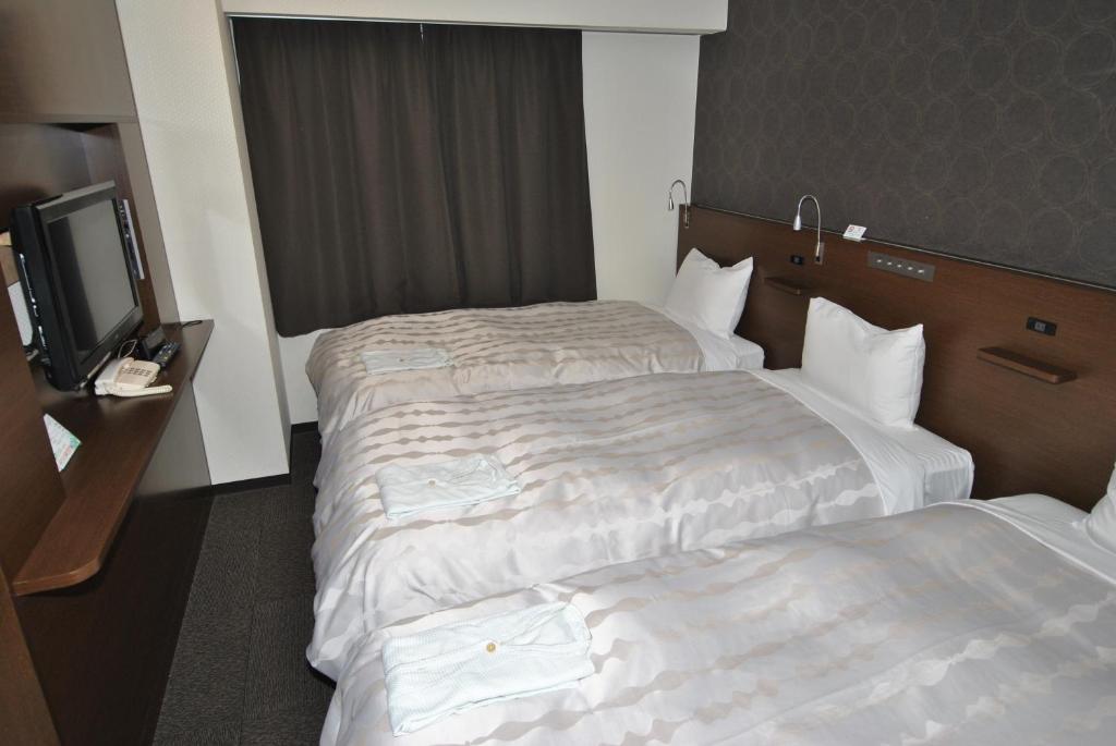 Postel nebo postele na pokoji v ubytování Hotel Mark-1 Abiko
