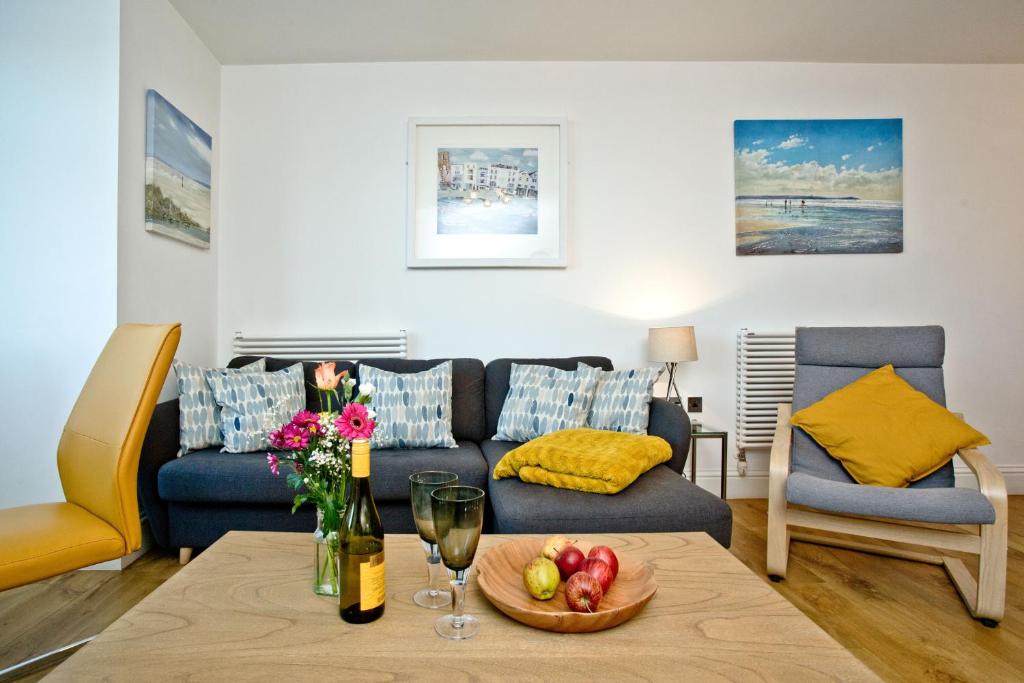 a living room with a couch and a table at 5 At The Beach in Beesands
