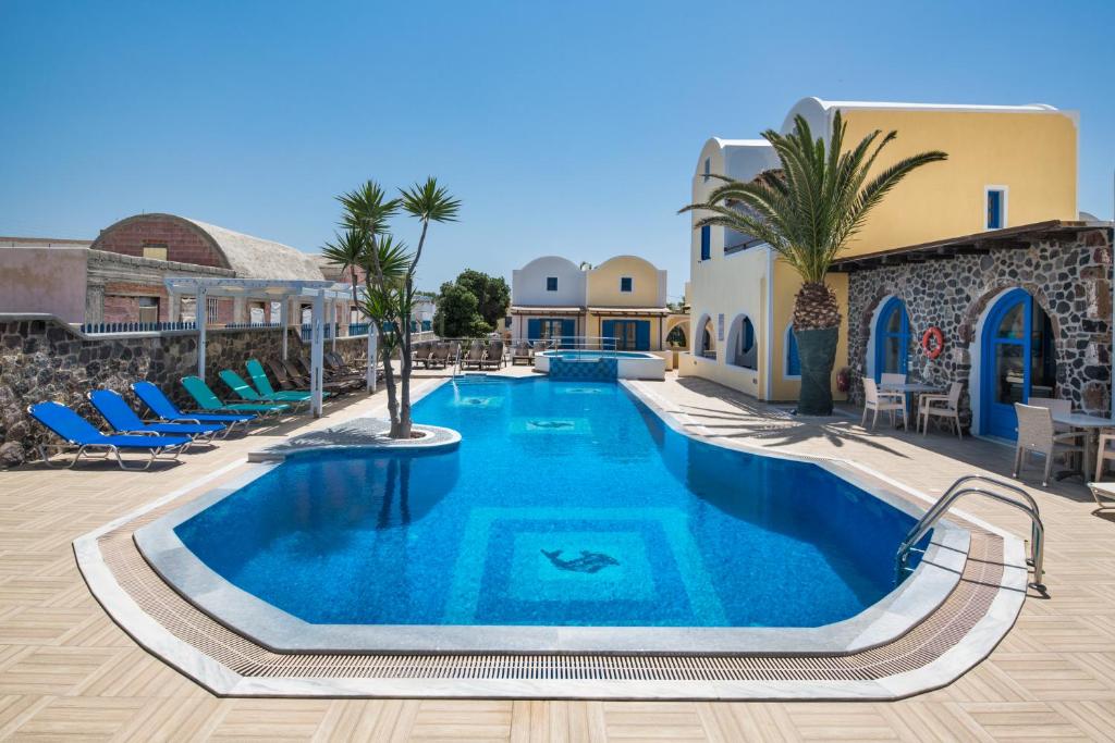 a swimming pool with blue water in a resort at Villa Eleftheria in Perivolos