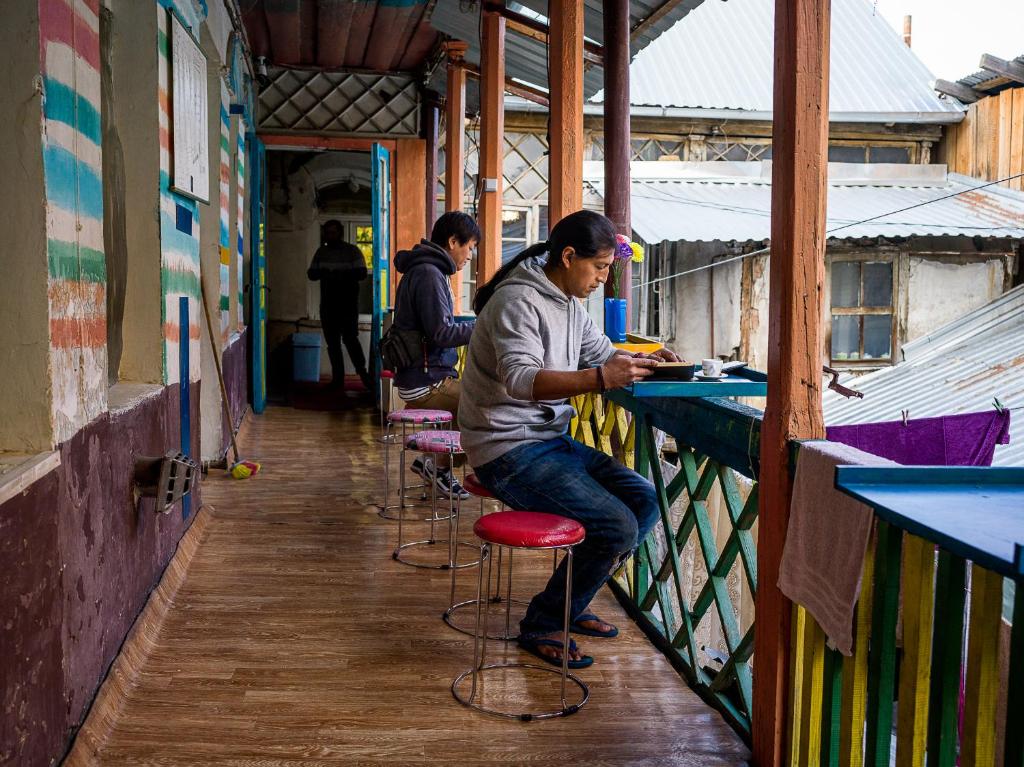 a man sitting at a bar in a building at My Hostel and Cooking House! in Tbilisi City