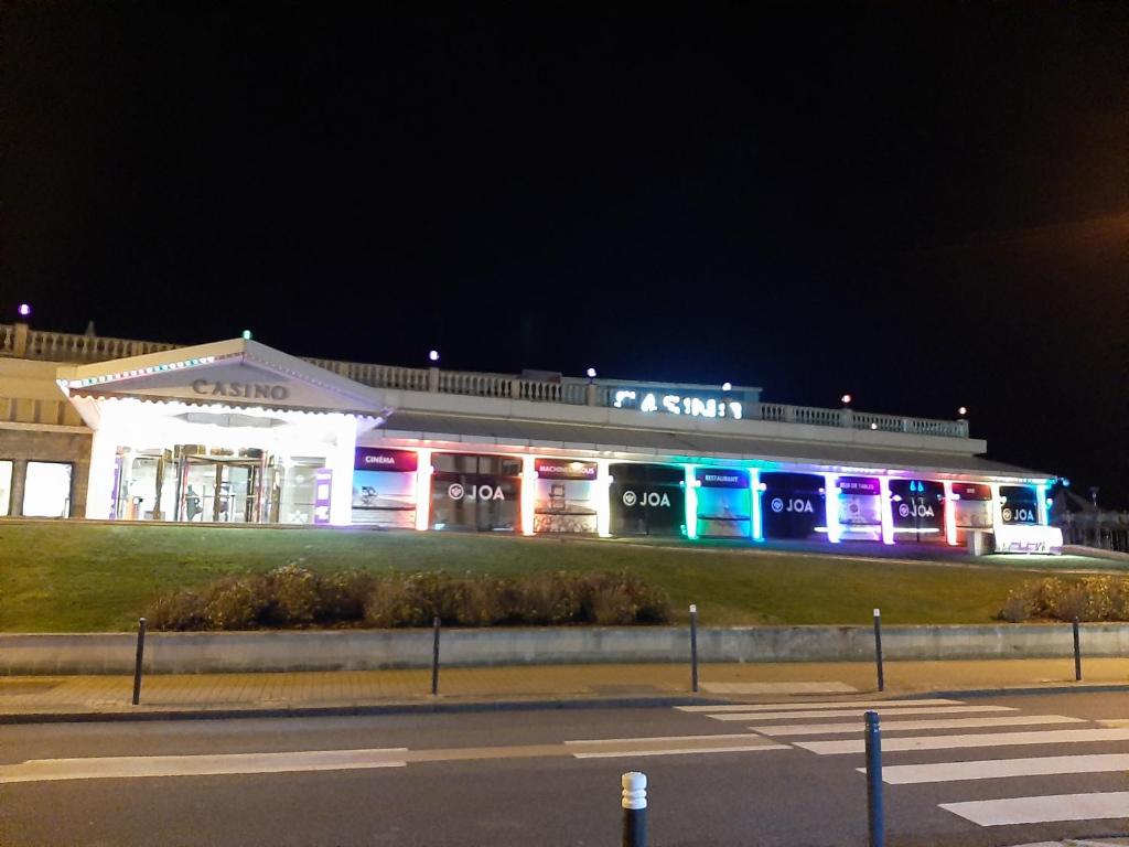 a lit up building with lights on at night at FLAB &#39; DES VENTS in Le Tréport