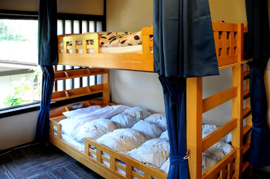 Postel nebo postele na pokoji v ubytování Sakura Guest House